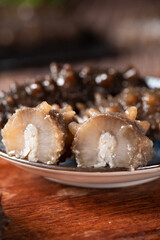 Raw sea cucumber trepang on wooden table.