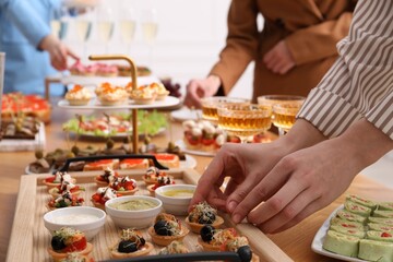 People with different appetizers at buffet, selective focus