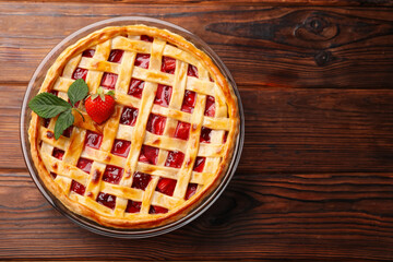 Tasty strawberry pie on wooden table, top view. Space for text