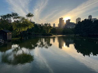 Lake park view and behind modern buildings silhouette at sunset in Istanbul, Turkey.