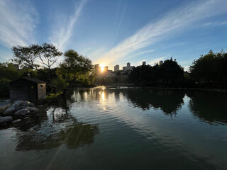 Lake park view and behind modern buildings silhouette at sunset in Istanbul, Turkey.