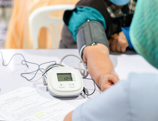 Blood pressure is checked before vaccination.