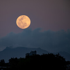 full moon over the mountain at dawn