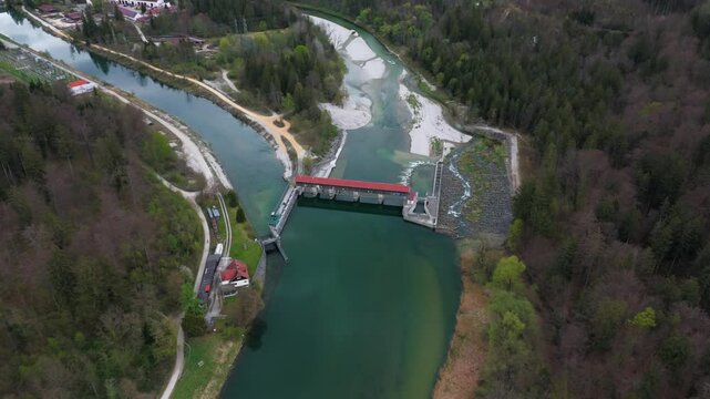 Drone footage of Baierbrunn weir, VLH turbine, and fish pass on the Isar River, Bavaria, Germany. Innovative hydropower, green energy, sustainable technology, and water engineering. Fischtreppe. 