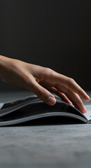 Stylish hand flipping through a luxury fashion magazine v3