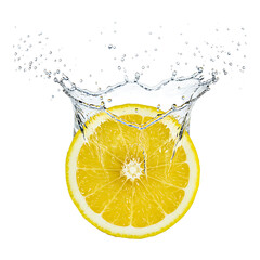 Juicy lemon slice submerged in clear water with splash crown on white background showing freshness and movement
