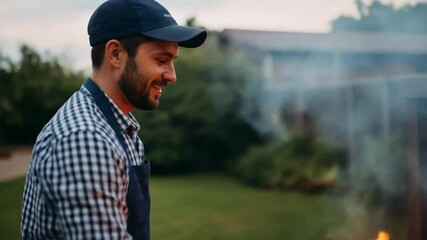 Man grilling meat outdoors on barbecue celebrating best dad with joy and care in garden