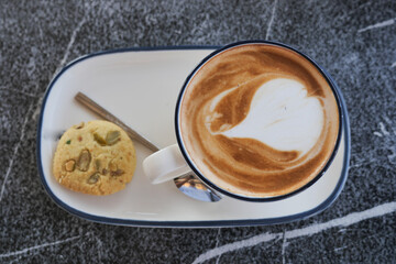 Cozy coffee and cookie on a marble table