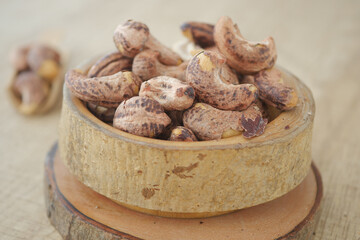Close-Up of Rustic Cashew Nuts in a Wooden Bowl on a Table