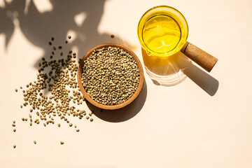 Hemp Seeds in Bowl and Hemp Seed Oil in a Clear Glass Pot. Cannabis Natural Product for Healthy...