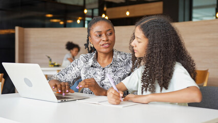 Tutor Guiding Student with Homework and Computer, Teacher and Student Collaborating on Computer at Home, Mother and Daughter Studying Together with Laptop