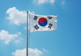 Naklejka premium Taegeukgi fluttering against a clear blue sky. A sunny day, a national symbol of the Republic of Korea