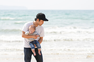 In early March, a 1-year-old Japanese girl explores the beach with curiosity while her parents in their 30s watch her closely. A warm springtime family moment by the sea filled with connection.