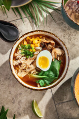 Chicken ramen with pak choi under bright natural light, overhead flatlay composition