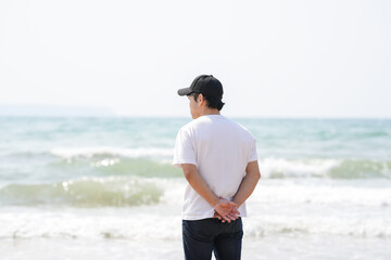 In early March, a Japanese man in his 30s spends time by the sea, standing on a sandy beach in the...