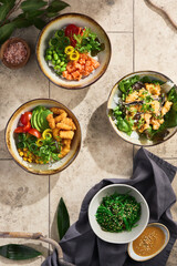 Asian-style salad bowls bright overhead, stone background composition