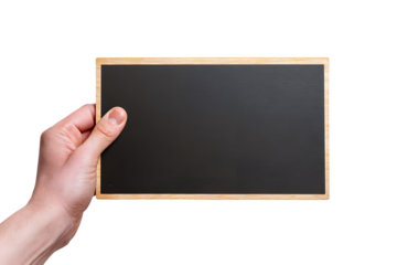 A hand holding a small black chalkboard with a wooden frame against a black background studio shot