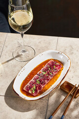 Tuna tataki with ponzu sauce, bright rustic lighting, overhead composition for wine bar menu