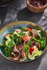 Roast beef salad with mixed greens, bright natural lighting, overhead composition