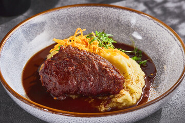 Braised beef cheek with mashed potatoes, rich sauce, bright rustic lighting, closeup composition