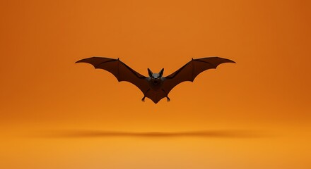 Fototapeta premium Flying bat on orange backdrop