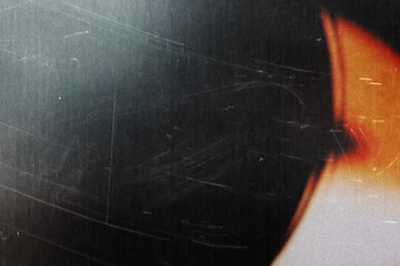 grungy black texture with vintage scratches and orange light leak for edgy web design, print media...