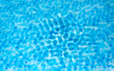 Blue water in the pool. Defocused blurred transparent blue colored clear calm water surface texture.