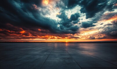 Empty concrete expanse beneath a dramatic sunset sky