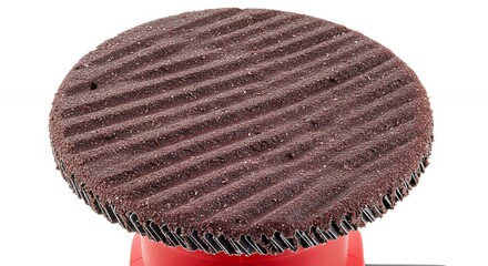 Dark brown circular disc with textured pattern