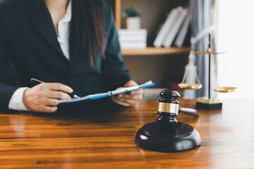 Justice and lawfirm concept. Female lawyer in office with brass scale. Woman hand gavel to bang. Law and justice trial session. Business lawyer notary stamping agreement, company secretary, validity.