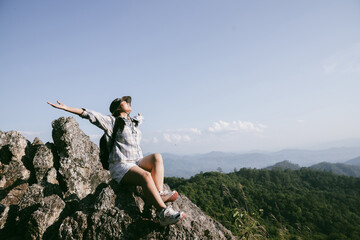 Woman hiker on top of mountain. Hiker with arms up on top of mountain successful young woman enjoying triumph. traveler exploring world. Hikers with backpacks relaxing. Sport and success concept.