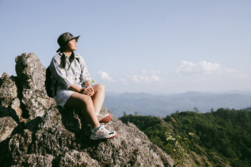 Woman hiker on top of mountain. Hiker with arms up on top of mountain successful young woman enjoying triumph. traveler exploring world. Hikers with backpacks relaxing. Sport and success concept.