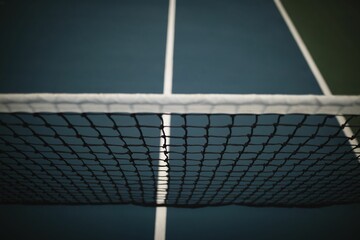 Flat design tennis net is stretching across outdoor court, showing blue surface and white lines