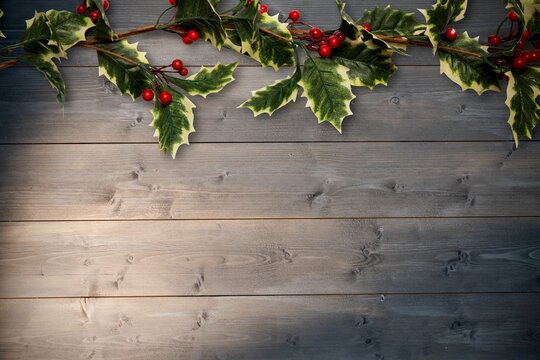 Holly twigs over wooden planks