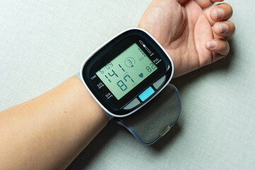 Woman check blood pressure monitor and heart rate monitor with digital pressure gauge. Health care...