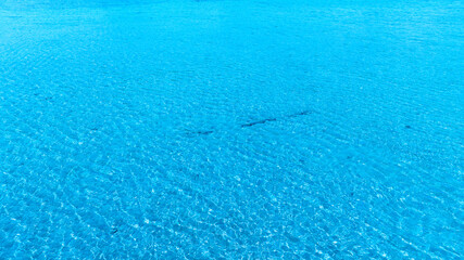Top view beach sand background for summer vacation concept. Beach nature and summer seawater with sunlight light sandy beach Sparkling sea water 