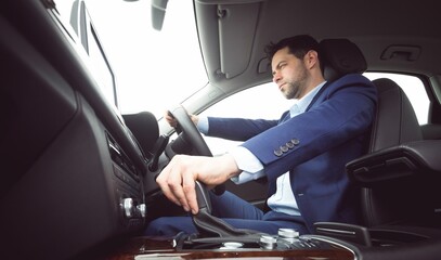 Businessman is operating steering wheel and gear lever in flat design car with infotainment screen
