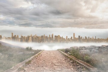 Stony path leading to large urban sprawl
