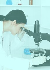 Female scientist looking through a microscope