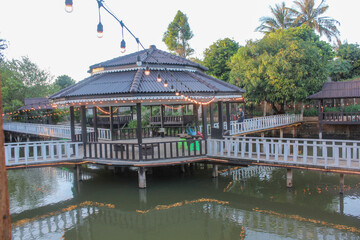 Obraz premium Traditional Chinese pavilion reflecting on a serene lake in an Asian garden, a timeless architectural beauty
