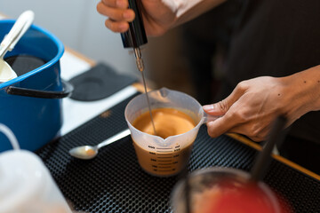 Man making a cup of Thai milk tea in bar counter at coffee shop cafe, Small business owner