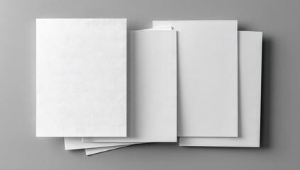 Blank white papers stacked on gray surface