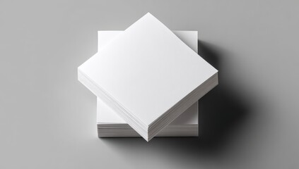 Two stacks of blank white square business cards