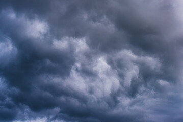Overcast dark blue sky with dark rain cloud in windy day.