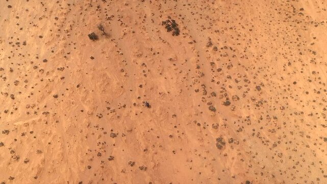 Top down aerial view reveals texture and pattern of arid, sandy desert floor near Tan-Tan, Morocco
