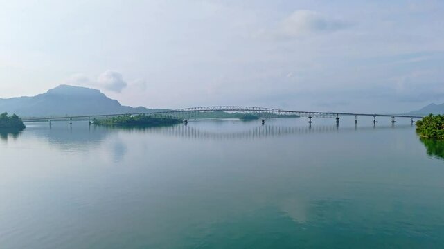 A stunning rising side-view aerial shot of the iconic San Juanico Bridge in the Philippines, captured in cinematic detail as the drone ascends alongside its full length from Samar to Leyte.
