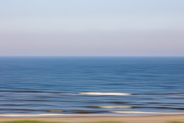 Blurred ocean waves creating abstract horizontal lines at dusk