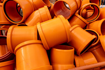 Orange pvc pipes stacked for plumbing or sewerage project
