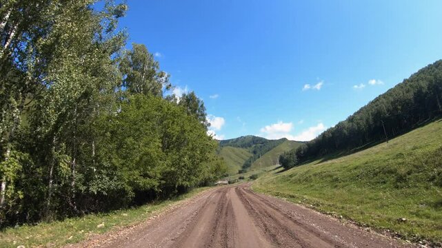 Video of driving in a car along country muddy road over village Nizhny Komar. in Altai Krai.