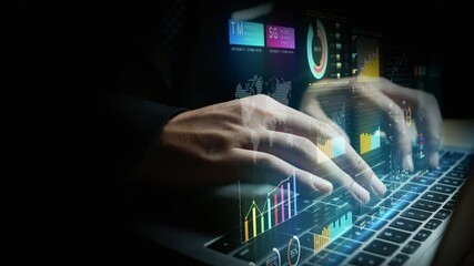 Businessperson using laptop with digital financial charts, global data analytics, and futuristic investment interface visuals for finance, marketing, and strategy - Powered by Adobe
